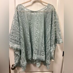 Size 1x- mint green lace poncho top with a geometric pattern and fringe detail